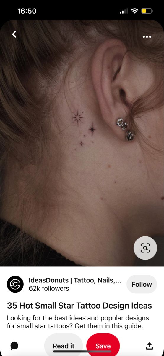 a woman's ear with small tattoos on it