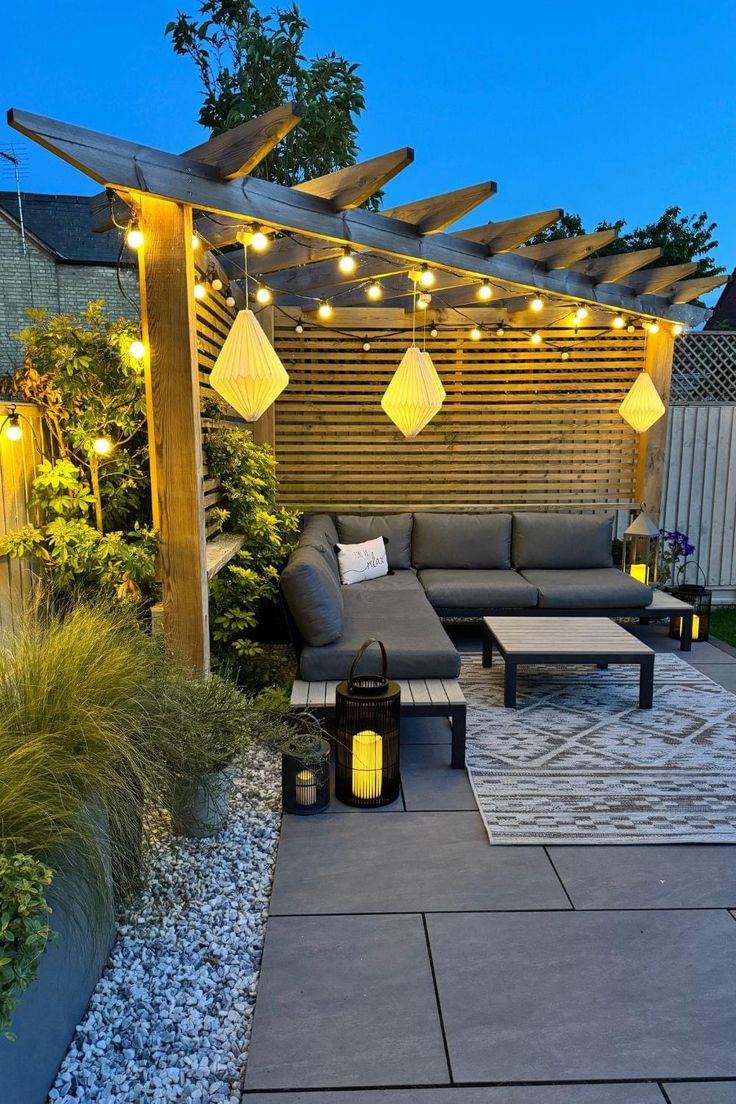 an outdoor living area with patio furniture and string lights on the pergolated roof