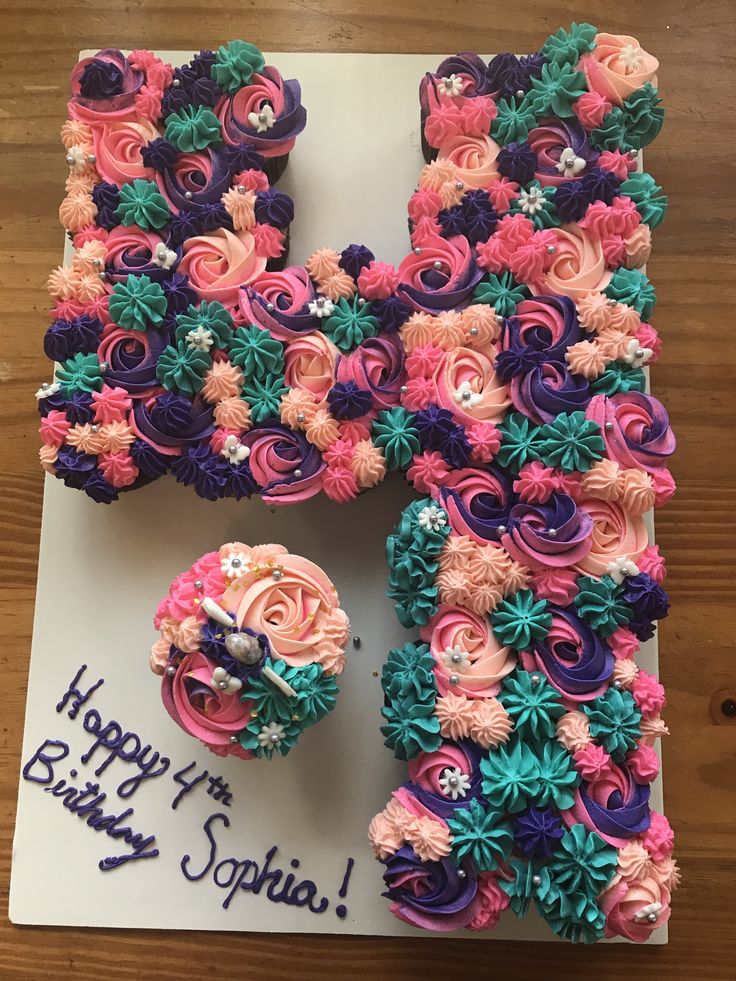 the letter f is made out of cupcakes and icing with flowers on it