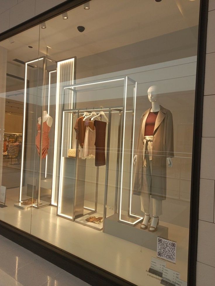 a store window with mannequins and shirts in it