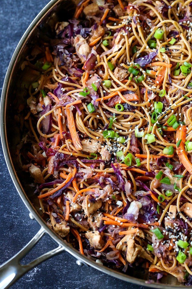 a pan filled with noodles and vegetables on top of a table