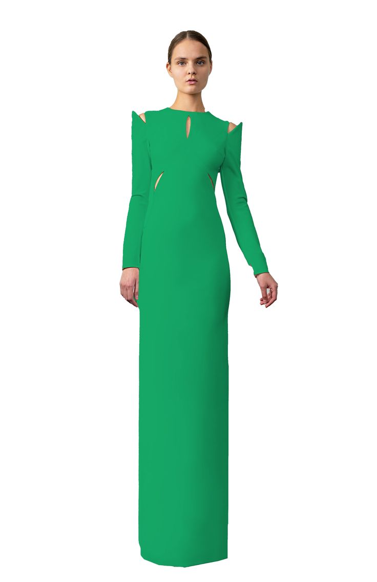 Styling: The Askia long fitted dress is a refined option designed for red-carpet affairs or formal gatherings. It commands attention with striking sleeves and daring cutouts, while its enduring silhouette exudes timeless elegance. This fully lined dress boasts a practical center back zipper, allowing for effortless dressing without disturbing your meticulously applied makeup. Elevate your style with this exquisite long-sleeve long evening dress from Michail, ideal for making a statement. Fit: This fitted stretch evening gown is true to size, offering both comfort and an excellent fit due to its fabric's elasticity. The model, standing at 5'10" tall, is wearing an XSmall size. Poly 94% Nylon 6% Elastane Dry clean Made in Los Angeles Ethical/Sustainable Practices: We prioritize environmental Elegant Green Dress With Cutout Details, Elegant Green Cutout Dress, Green Evening Dress With Back Opening, Long Sleeve Cutout Maxi Dress For Party, Elegant Fitted Dress With Cutaway Shoulders, Formal Long Sleeve Cutout Dress, Floor-length Evening Dress With Side Slits, Fitted Maxi Dress With Cutout For Formal Occasions, Elegant Long Dress With Cutout