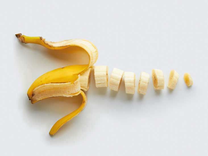 a peeled banana sitting on top of a white table