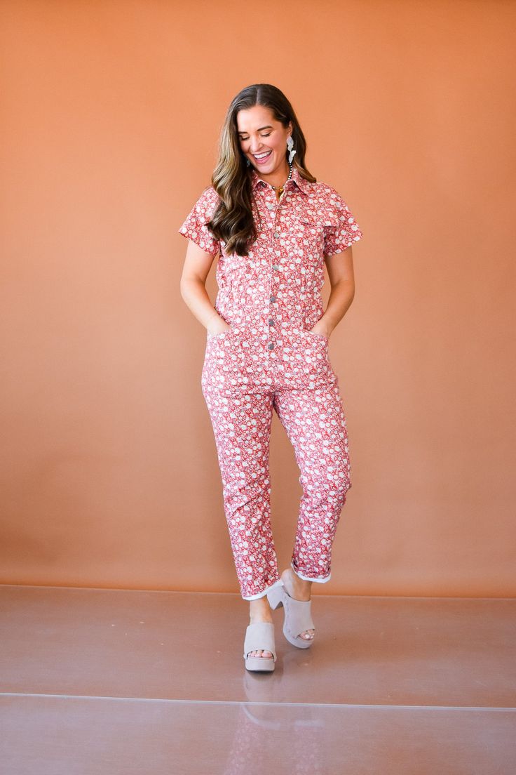 The Winnie Floral Denim Jumpsuit is your versatile go-to outfit for any occasion. Its gorgeous floral print in red and ivory will turn heads, while the buttons, stretch, and elastic waist provide comfort and style. Rock it with sneakers for a casual look or dress it up with heels for a more sophisticated vibe. Product Details: measurements: BUST: small 18" medium 18.5" large 19" INSEAM: small 25.5" medium 26" large 26.5" RISE: small 31.5" medium 32" large 32.5" 60% cotton, 38% polyester, 2% span Skort Outfit, Nickel And Suede, Style Rock, Floral Denim, Trend Report, Denim Jumpsuit, Fall Trends, Bottoms Pants, Denim Dress