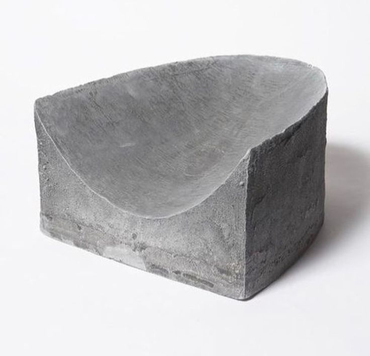 a stone bowl sitting on top of a white table