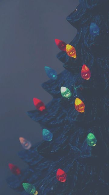 a christmas tree with multi colored lights on it