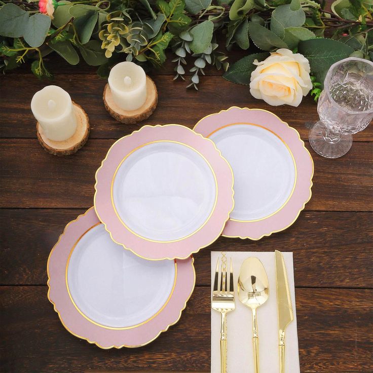 pink and gold place setting on wooden table