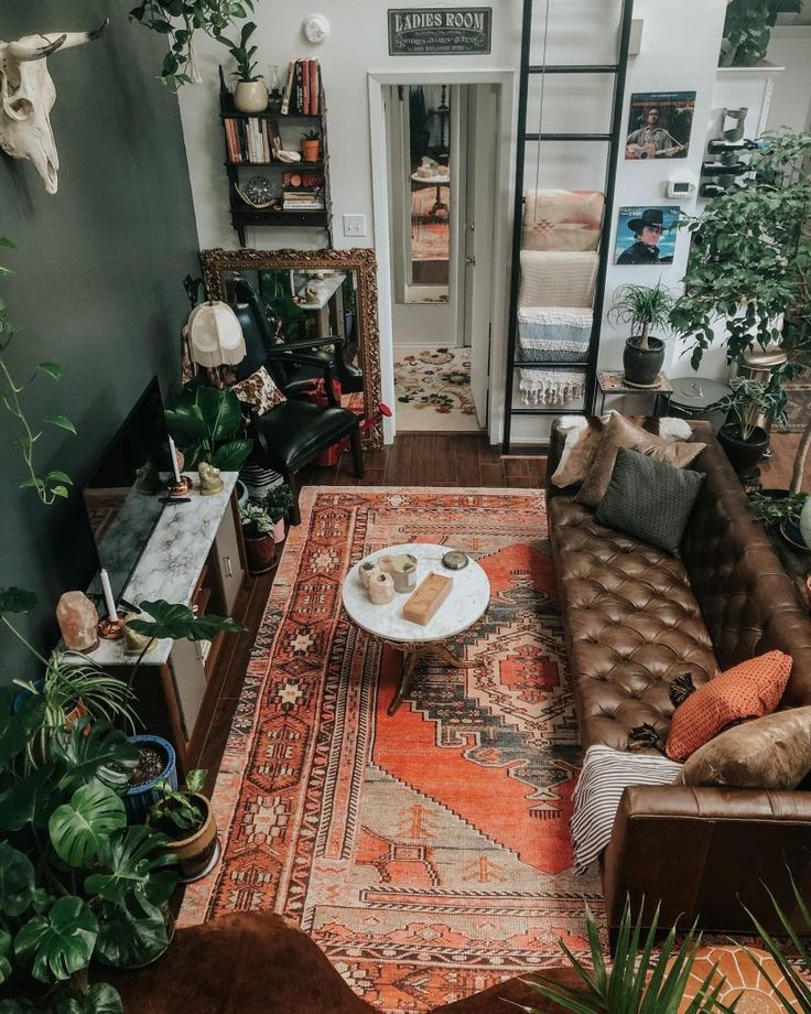 a living room filled with furniture and lots of plants