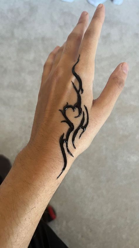 a person's hand with a tattoo on it