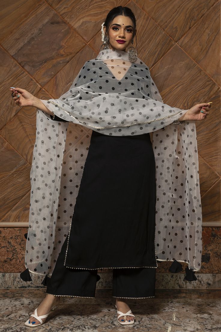 Featuring a black kurta in rayon base. It is paired with matching pants and an organza dupatta.The biggest luxury blowout end of season sale up to 70% off on marvellous kurta sets. #Perniaspopupshop #womenswear #ethnic #whatiworewastrending #ppuslove #kurtaset #rawsilk #rayon #organza #black #weddingwear #engagement #haldi #mehendi #festivewear #embroiderdkurta Polka Dot Suits Women Indian, Polka Dots Kurti Indian, Suits For Women Indian, Dupatta Dress, Black Kurti, Ethnic Wears, Design Kurta, Lawn Dresses, Trendy Outfits Indian