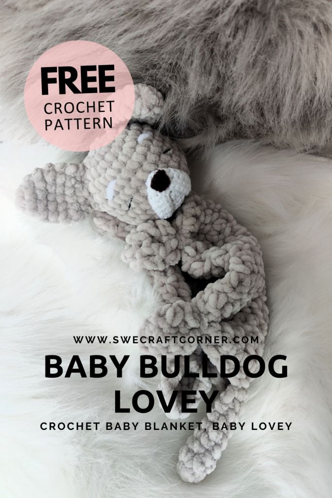 a crocheted teddy bear laying on top of a white fur covered bed with text overlay that reads, free crochet pattern baby bulldog love