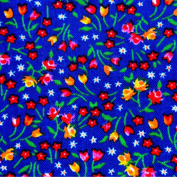 a blue background with red, yellow and white flowers on it's side is shown