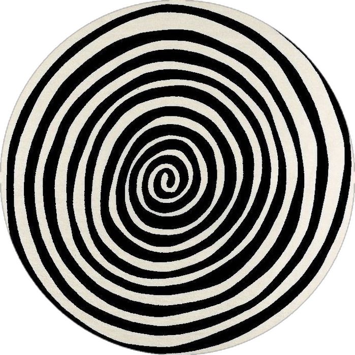 a black and white circular rug with an abstract design