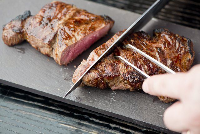 someone is cutting up some meat on a board