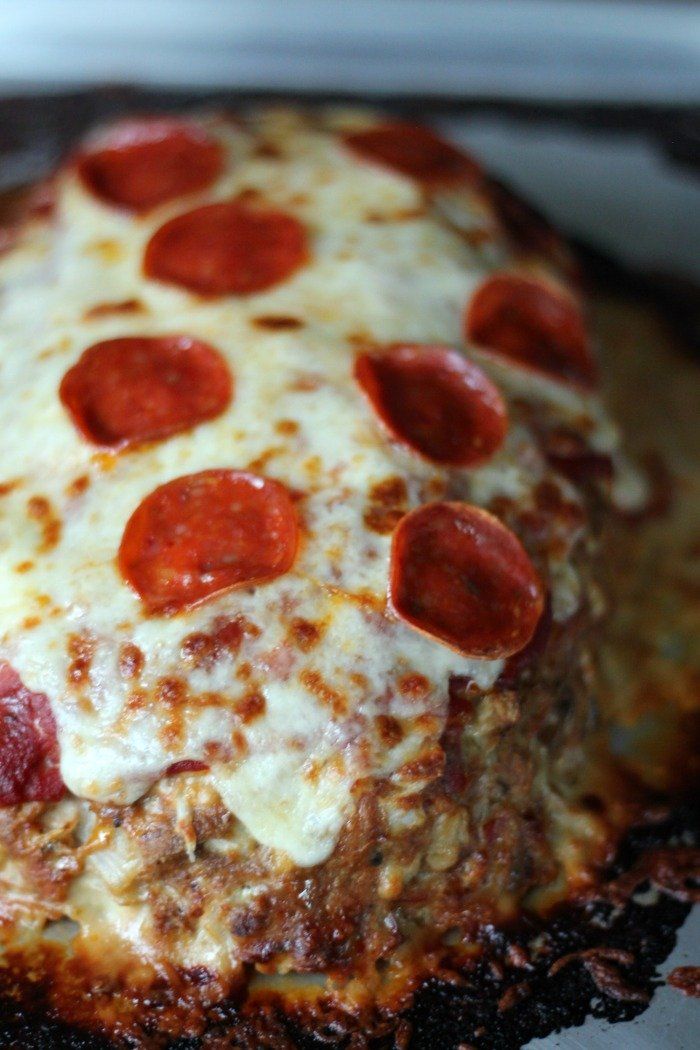 a pepperoni pizza sitting on top of a metal pan covered in cheese and sauce