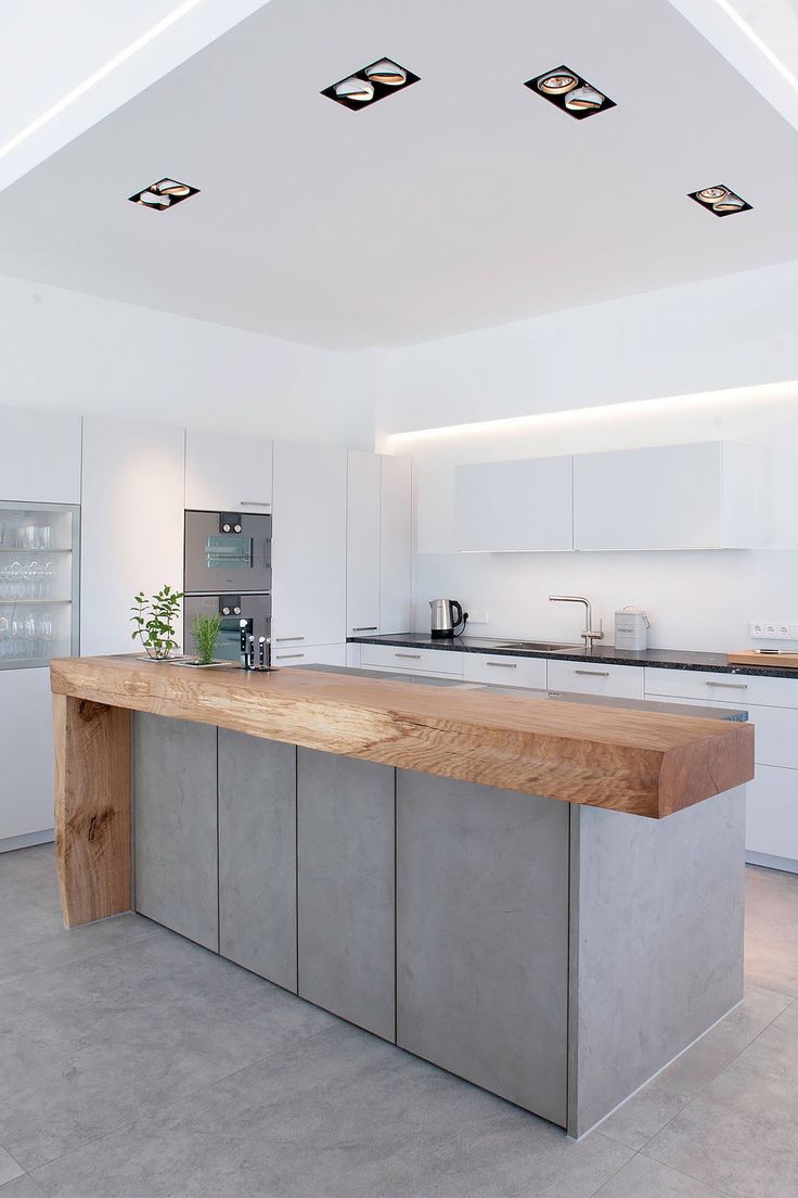 a modern kitchen with stainless steel appliances and wood counter tops