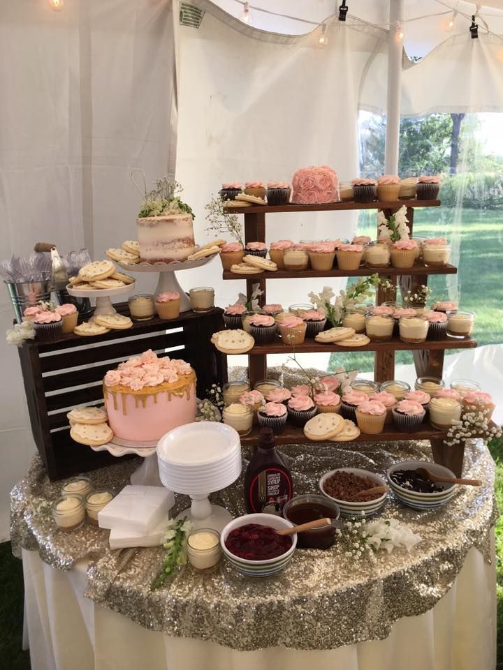 a table topped with lots of cupcakes and cakes