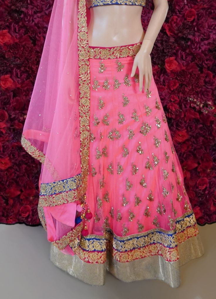 Go all out in this whimsical lehenga, studded with precious mirror, pearl, stone, embroidery work, which is sure to bring out the innate grace and grandeur in you! Color - Mauvelous Pink Fabric & Work Style - - Silk blouse: mirror, pearl, stone, embroidery work. - Soft net lehenga: mirror, pearl, stone, embroidery work. - Soft net dupatta: embroidery work. Details - - Assured quality - Wash care instruction: Dry clean only. - Slight variation in color is possible due to digital photography. Embellished Raw Silk Choli For Wedding, Wedding Choli In Embellished Raw Silk, Bollywood Style Embellished Choli For Reception, Wedding Embellished Raw Silk Choli, Elegant Kundan Lehenga With Gota Work, Designer Embellished Raw Silk Choli, Embellished Raw Silk Choli For Designer Wear, Wedding Choli With Mirror Work In Raw Silk, Wedding Raw Silk Choli With Mirror Work