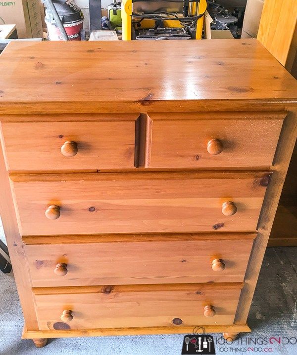 a wooden dresser sitting inside of a garage