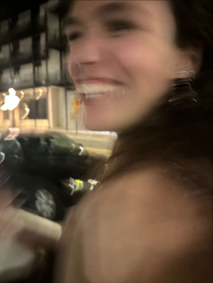 a blurry photo of a woman smiling