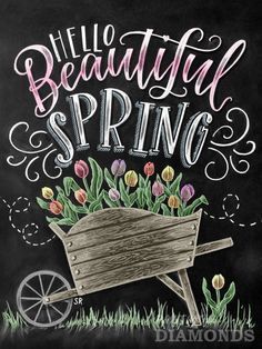 a chalkboard sign that says hello beautiful spring with flowers in the wheelbarrow