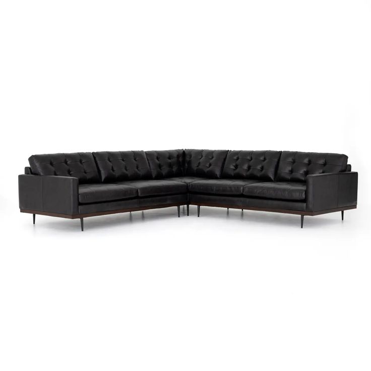 a black leather sectional sofa with metal legs and footrests on an isolated white background