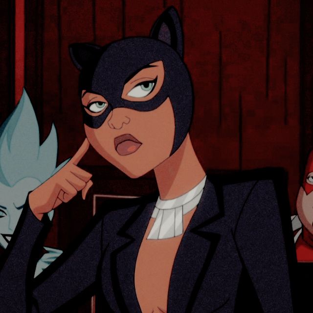 a woman in a catwoman costume pointing to her left side while another woman looks on