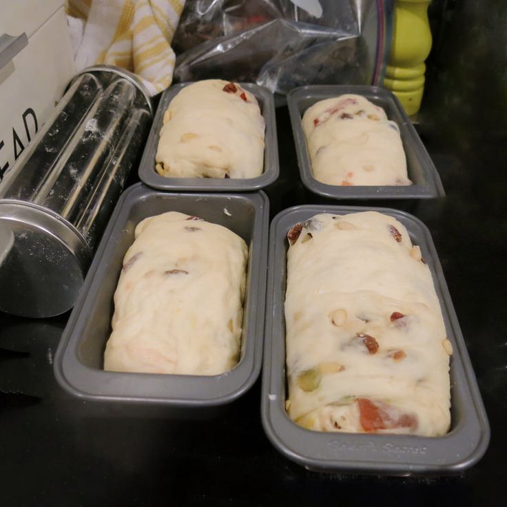 four pans filled with food sitting on top of a counter