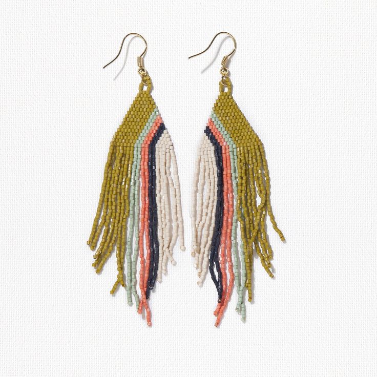 Our precision-cut glass Luxe beads in a daringly groovy colorway are just what your jewelry box is missing. Citron, mint, coral, navy + ivory beads are handwoven into a triangle shape with a modern diagonal stripe design that brings boho style to life in an approachable way. Flowy fringe takes these statement earrings to a whole new level with movement that turns heads with any outfit. Life is short - accessorize boldly. Citron, Mint, Coral + Navy Colors 4"L Made By Artisans In India Glass + Bra Bohemian Triangle Beaded Earrings, Unique Multicolor Geometric Jewelry, Multicolor Beaded Geometric Earrings, Adjustable Geometric Beaded Jewelry, Adjustable Triangular Beaded Jewelry, Adjustable Triangle Beaded Jewelry, Handmade Multicolor Geometric Jewelry, Handmade Geometric Multicolor Jewelry, Mint Coral