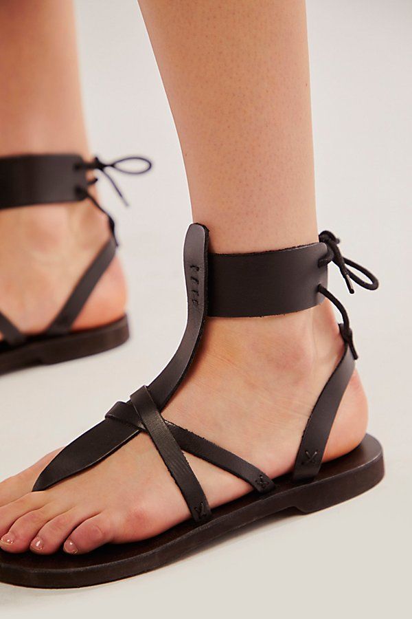 Strappy leather sandals featuring a wraparound ankle detail with a lace-up back; the partial vegetable-tanned leather sandal molds to your foot and softens with each wear. * Adjustable back ties * Slight heel * EVA footbed **Fit Note:** This style runs true to size. If between sizes, we suggest sizing down. | Vacation Day Wrap Sandals by FP Collection at Free People in Black, Size: EU 36 Leather Ankle Strap Lace-up Sandals With Leather Footbed, Adjustable Ankle Wrap Lace-up Sandals, Spring Festival Lace-up Toe Loop Sandals, Spring Festival Lace-up Sandals With Ankle Tie, Ankle Tie Lace-up Sandals For Spring Festival, Spring Lace-up Open Toe Sandals With Leather Sole, Leather Lace-up Sandals For Festivals, Leather Lace-up Sandals With Ankle Strap, Leather Ankle Tie Sandals With Heel Loop