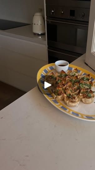 a yellow and blue plate with food on it sitting on a kitchen counter next to an oven