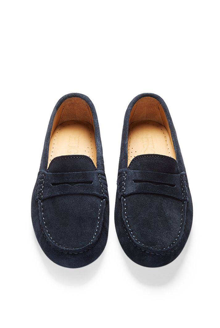 Moccasin style driving loafers in luxurious blue suede outer and lined with a soft leather for extra comfort. A great staple colour for any wardrobe. We also offer this same navy blue suede in tasselled or the full rubber soled penny version. Made in Portugal. MATERIAL 100% suede upper featuring a 100% leather Liningrubber studded sole Navy Suede Loafers With Rubber Sole, Navy Suede Slip-on Loafers, Classic Navy Loafers With Leather Sole, Navy Suede Loafers For Formal Occasions, Classic Blue Moccasins With Suede Lining, Casual Navy Suede Loafers, Navy Loafers With Leather Sole For Work, Classic Blue Loafers With Suede Lining, Classic Blue Moccasins With Stitched Sole