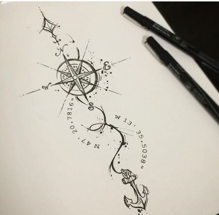 a pen and ink drawing of an anchor, star and compass on paper with two black markers