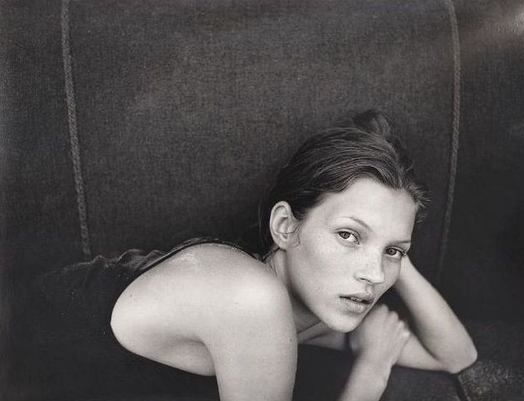 black and white photograph of a woman laying on a couch