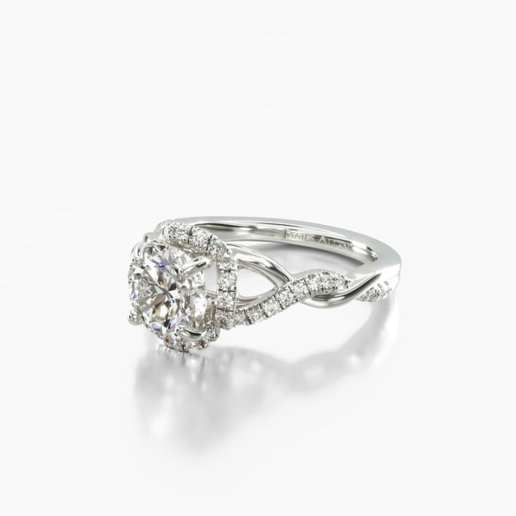 a white gold ring with an oval diamond in the center and two round diamonds on each side