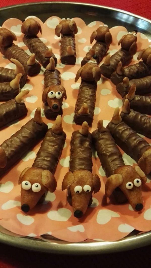 there are many sausages with googly eyes on the tray that is ready to be eaten