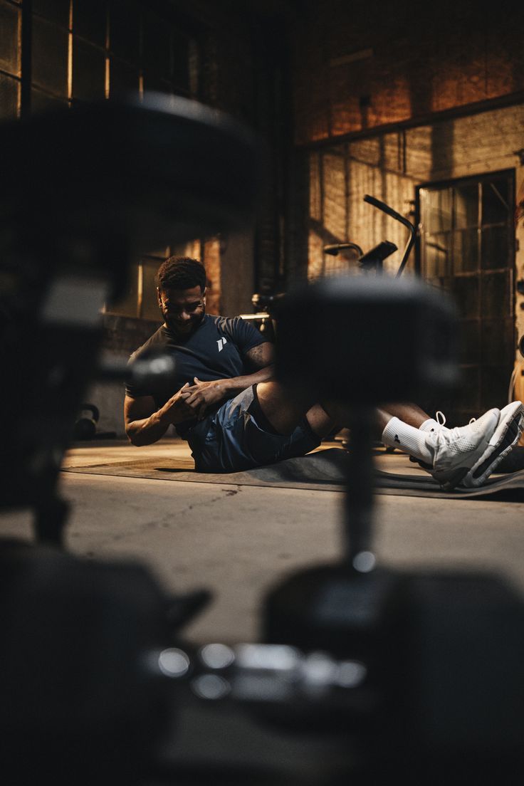 a man sitting on the ground in front of a camera