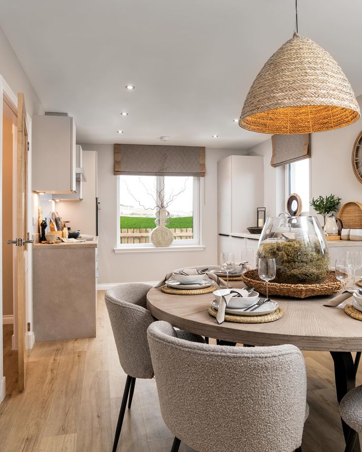 a dining room table with chairs and plates on it