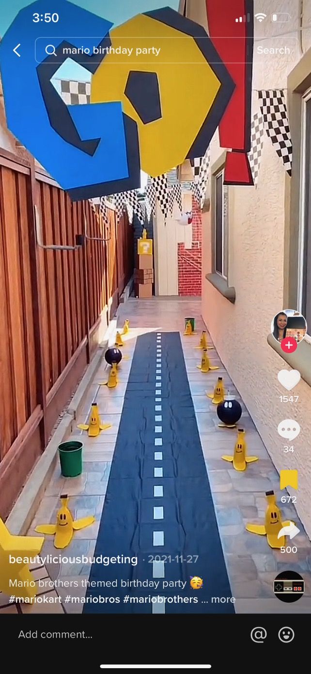 an image of a long table with yellow rubber ducks on it and balloons in the air