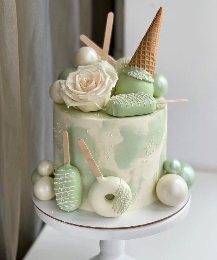 a cake decorated with green and white decorations