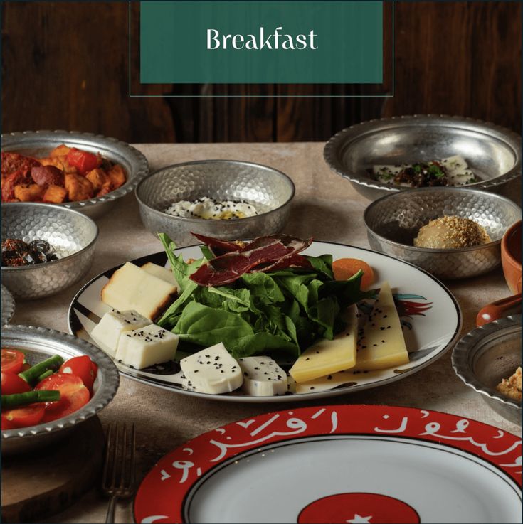 a table topped with plates and bowls filled with food