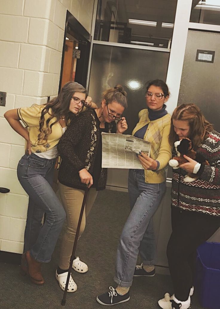 four girls looking at a map in the hallway