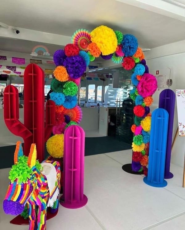 colorful paper flowers decorate the entrance to an art gallery