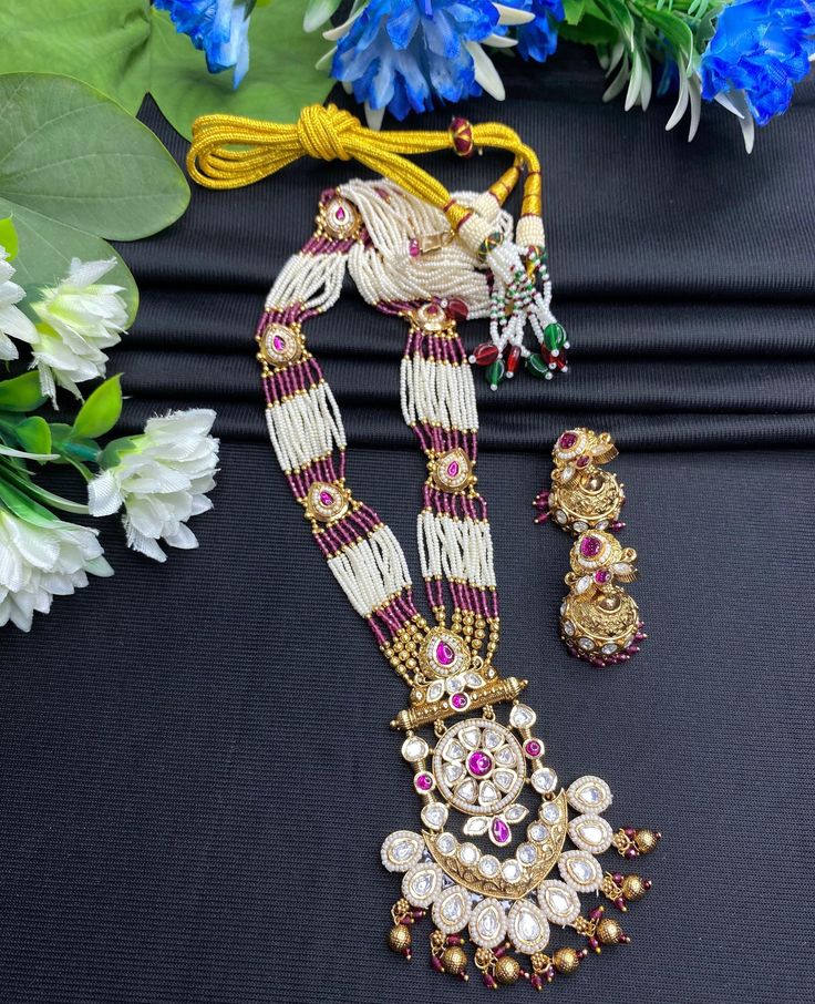 Your traditional attire with this exquisite Heer Rajwadi Kundan long Meenakari Necklace with Jhumka Earring set, featuring a stunning combination of gold and pink hues. Perfect for special occasions, this set exudes elegance and sophistication, making it a must-have addition to your jewelry collection. Style & Look: Elevate your style with the Heer Rajwadi Kundan long Meenakari necklace, beautifully complemented by Jhumka earrings. This exquisite set combines the regal allure of Rajwadi design w Luxury Festive Meenakari Necklaces, Temple Jewelry Bridal Necklace With Latkans For Eid, Cutdowna Jewelry Sets For Puja During Diwali, Eid Jewelry With Zari Work For Puja, Zari Work Jewelry For Eid Puja, Zari Work Jewelry For Puja And Eid, Bollywood Jewelry With Zari Weaving For Wedding, Bollywood Style Wedding Jewelry With Zari Weaving, Traditional Bridal Necklace With Latkans For Eid