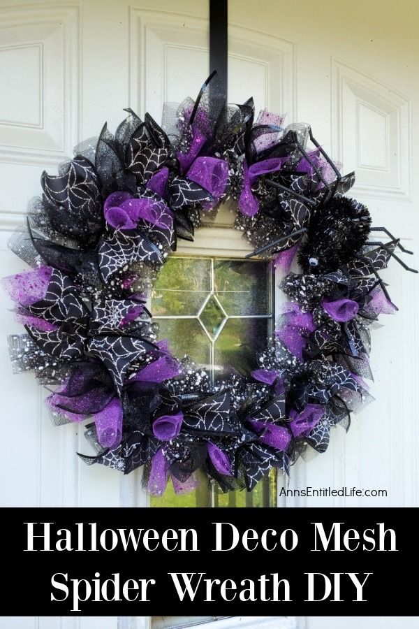 a halloween deco mesh spider wreath hanging on a front door with text overlay that reads, halloween deco mesh spider wreath diy