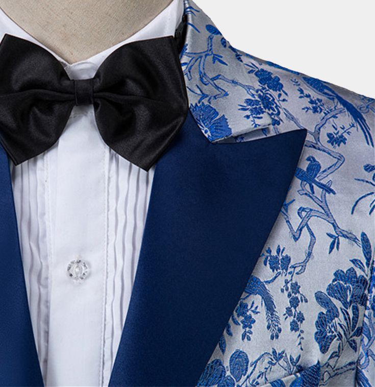 When it comes to wearing floral prints, it can be quite an art to be able to pull off such a feat. For instance, you can project a suave and fun vibe, with this astonishing electric blue floral tuxedo, you are bound to be the former – rest assured, you will look incredibly dashing and smart! The floral embroidery is beautiful and the electric blue hues tremendously accentuate visual appeal. The lapel, pocket trim, and buttons are also in a similar shade for a great finish. The light-colored back Blue Prom Tuxedo, Floral Tuxedo, Prom Tuxedo, Velvet Bow Tie, Red Pocket, Velvet Loafers, Silk Pocket Square, Polyester Pants, Tuxedo Shirts