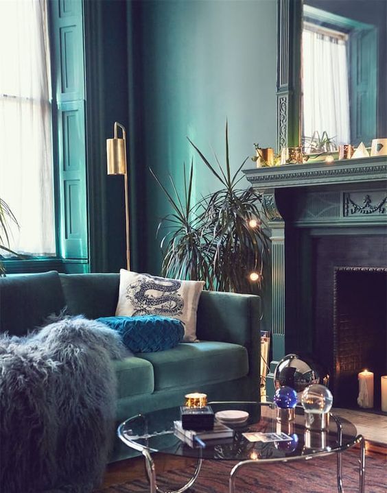 a living room filled with furniture and a fire place in front of a mirror wall