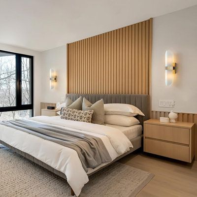 a large bed sitting in the middle of a bedroom next to a tall glass window