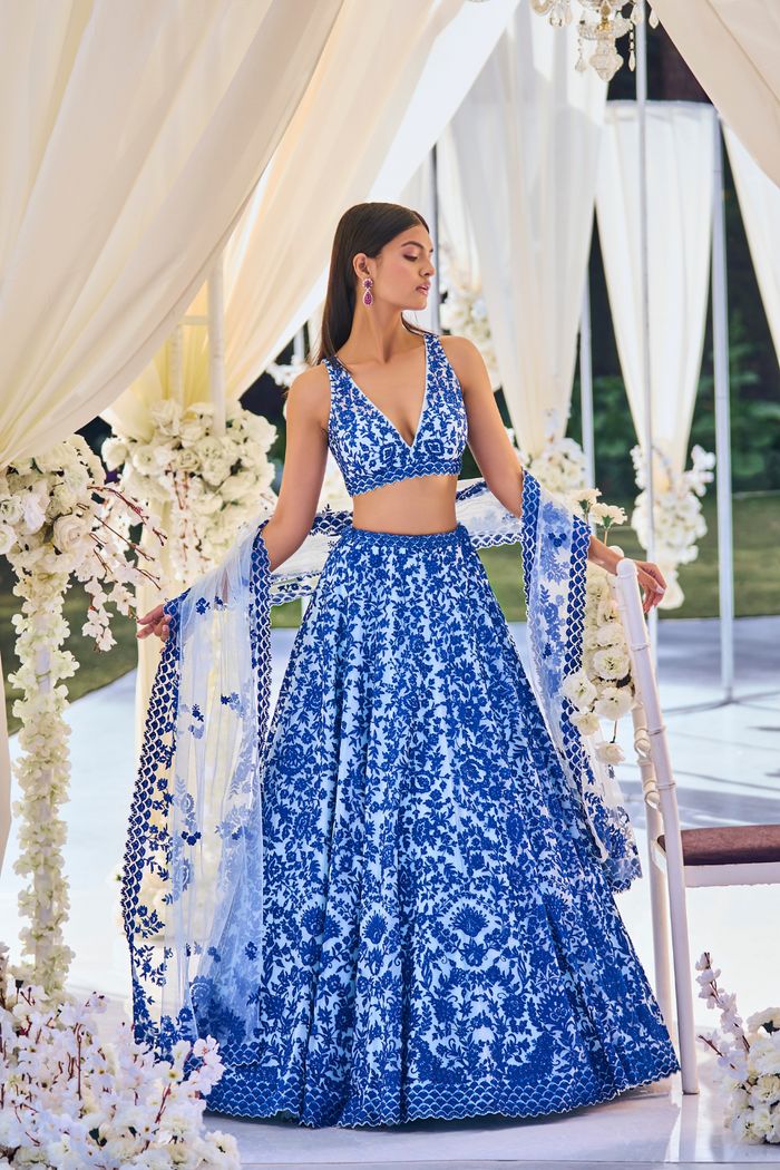 This blue lehenga set features intricate resham embroidery on softest tulle. The outfit is paired with a v-neck blouse and with a four-sided embroidered net dupatta.From Seema Gujral's Tuscan Summer collection. DELIVERY TIMEPlease allow 8-12 weeks for your outfit to arrive. FABRIC DETAILSNet Professional cleaning only. Latest Lehenga Designs, Seema Gujral, Resham Embroidery, Trendy Outfits Indian, Indian Outfits Lehenga, Resham Work, Wedding Lehenga Designs, Work Lehenga, Blue Lehenga