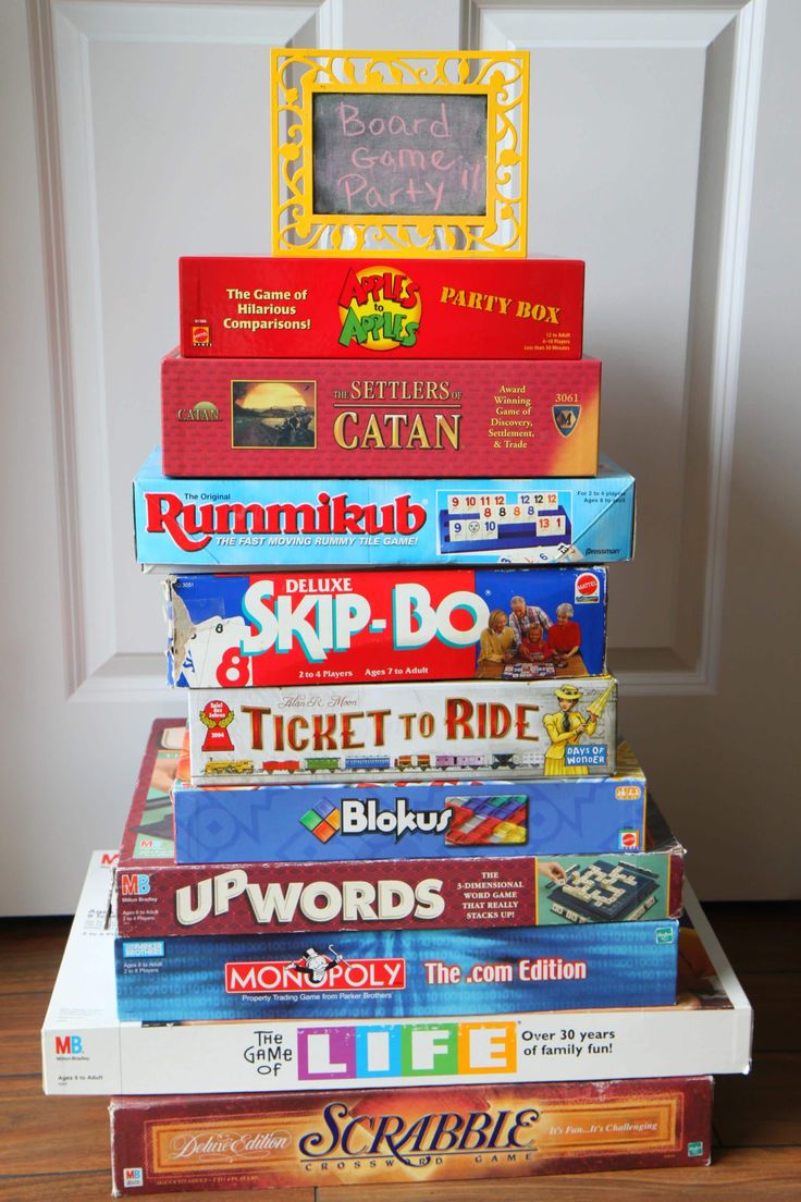 a stack of children's board games sitting on top of each other in front of a door